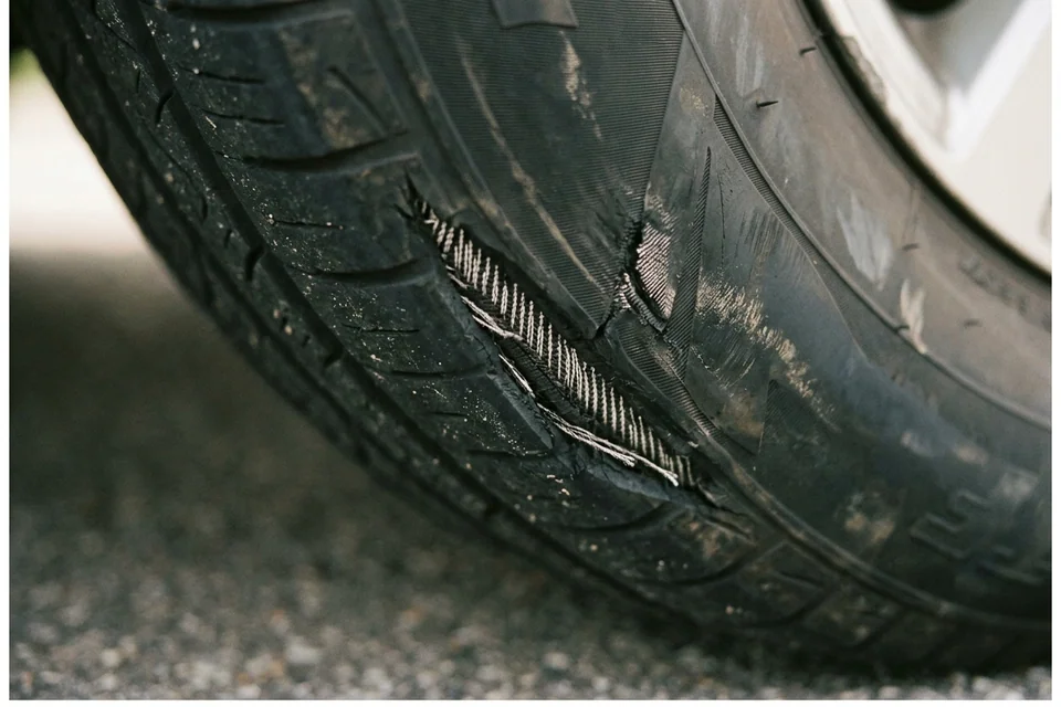 Close view of a sidewall cut with fabric cords showing through the rubber